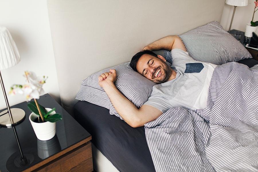 young man feeling well rested when using sleep apnea treatment