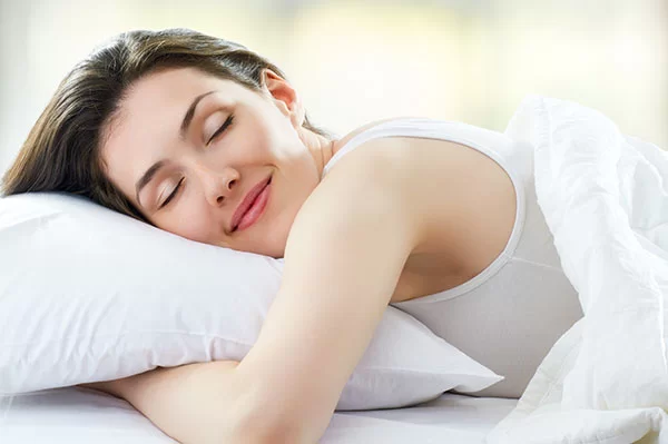 woman sleeping soundly after finding a sleep apnea treatment